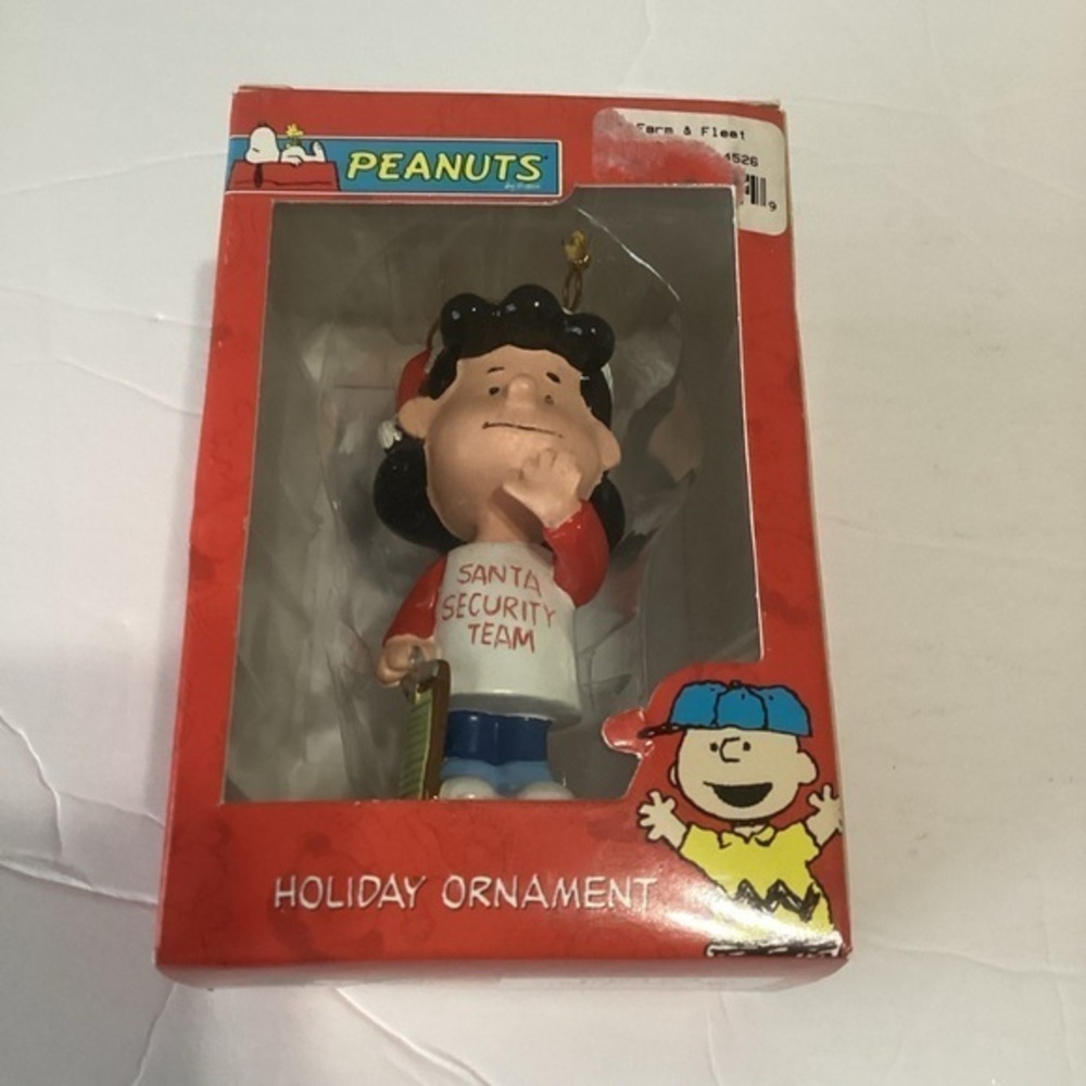 Peanuts Lucy Holiday Ornament Lucy in a “Santa Security Team” T-shirt